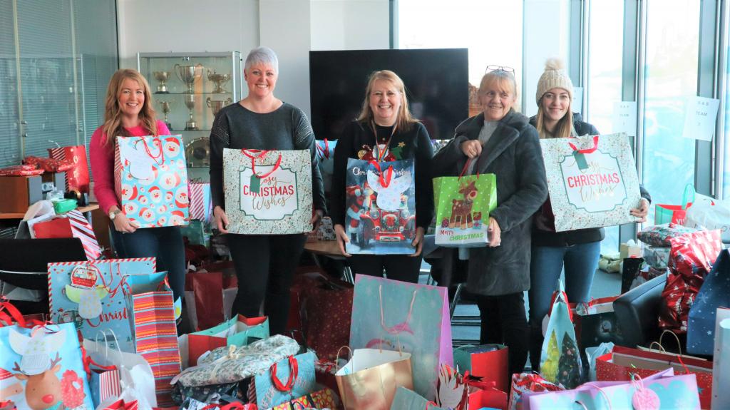 Council employees with staff from the Keel Row pub holding donated presents.