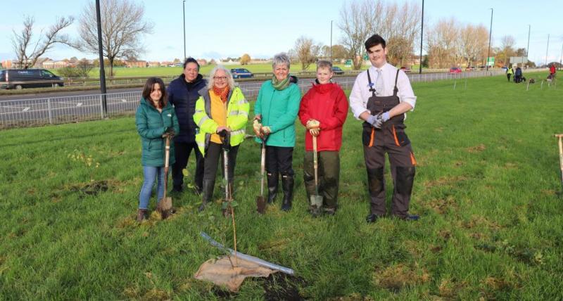 Councillors and volunteers helping to plant