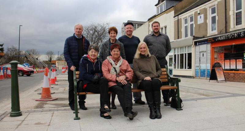 Residents sitting on a chair at the revamped area