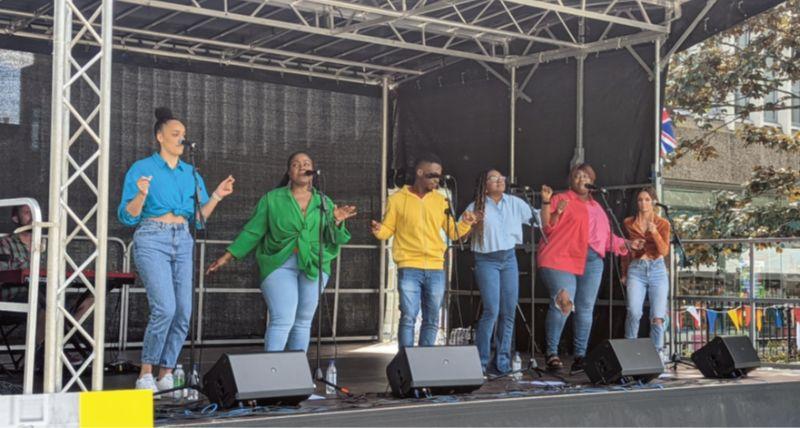 A band on stage at North Tyneside Together festival wearing colourful outfits